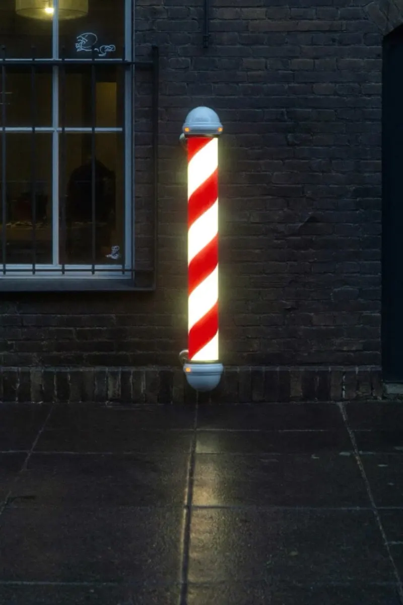 Barber pole outside 605 Barbershop